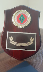 Award plaque recognising Dr. Ugochukwu for outstanding knowledge, health and service